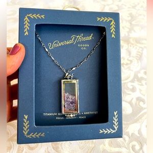 Beautiful Universal Thread with purple stones in clear box.